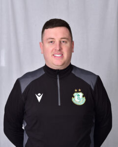 Portrait of a Shamrock Rovers football player in team kit.