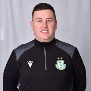 Portrait of a Shamrock Rovers football player in team kit.