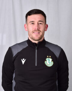 Player in Shamrock Rovers football kit, smiling at camera.