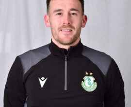 Player in Shamrock Rovers football kit, smiling at camera.