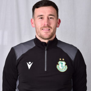 Player in Shamrock Rovers football kit, smiling at camera.