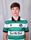 Young Shamrock Rovers player in green and white jersey, facing forward.