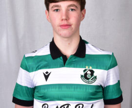 Young Shamrock Rovers player in green and white jersey, facing forward.