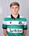 Shamrock Rovers football player in team jersey, standing against a neutral background.