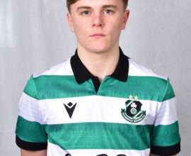 Shamrock Rovers football player in team jersey, standing against a neutral background.