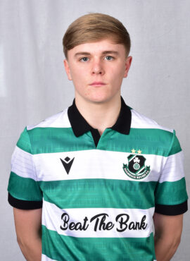 Shamrock Rovers football player in team jersey, standing against a neutral background.