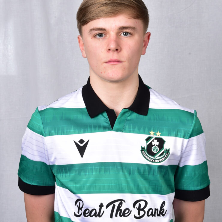 Shamrock Rovers football player in team jersey, standing against a neutral background.