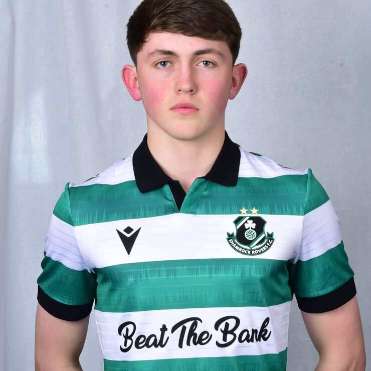 Young Shamrock Rovers player in team jersey, standing confidently.