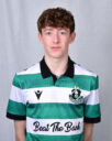 Young Shamrock Rovers player in team jersey, standing against grey background.