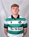 Young Shamrock Rovers footballer in green and white kit, standing confidently.