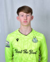 Young Shamrock Rovers goalkeeper in bright green kit with club crest.