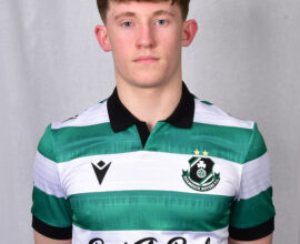 Young Shamrock Rovers footballer in team kit, facing camera, neutral background.