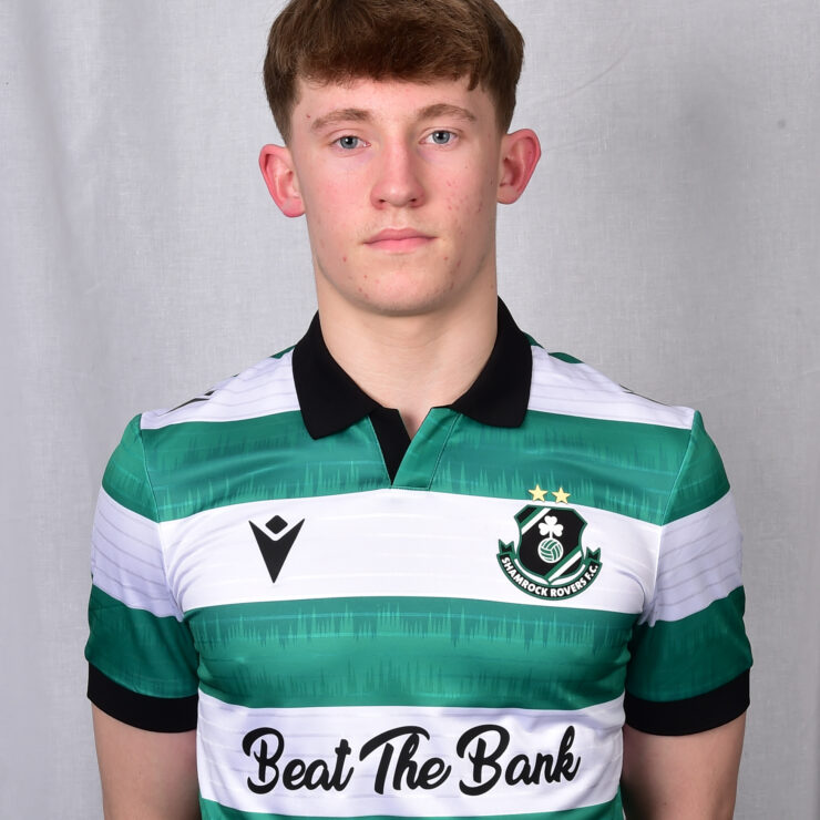 Young Shamrock Rovers footballer in team kit, facing camera, neutral background.