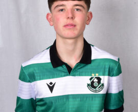 Player in Shamrock Rovers football kit, showcasing team colours and logo.