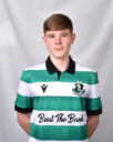 Young football player in Shamrock Rovers kit with green and white stripes.