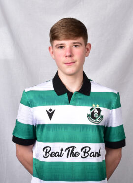 Young football player in Shamrock Rovers kit with green and white stripes.