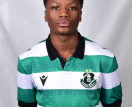 Female Shamrock Rovers player in green and white jersey, standing confidently.