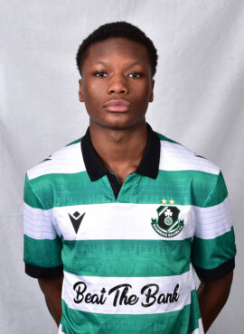 Female Shamrock Rovers player in green and white jersey, standing confidently.