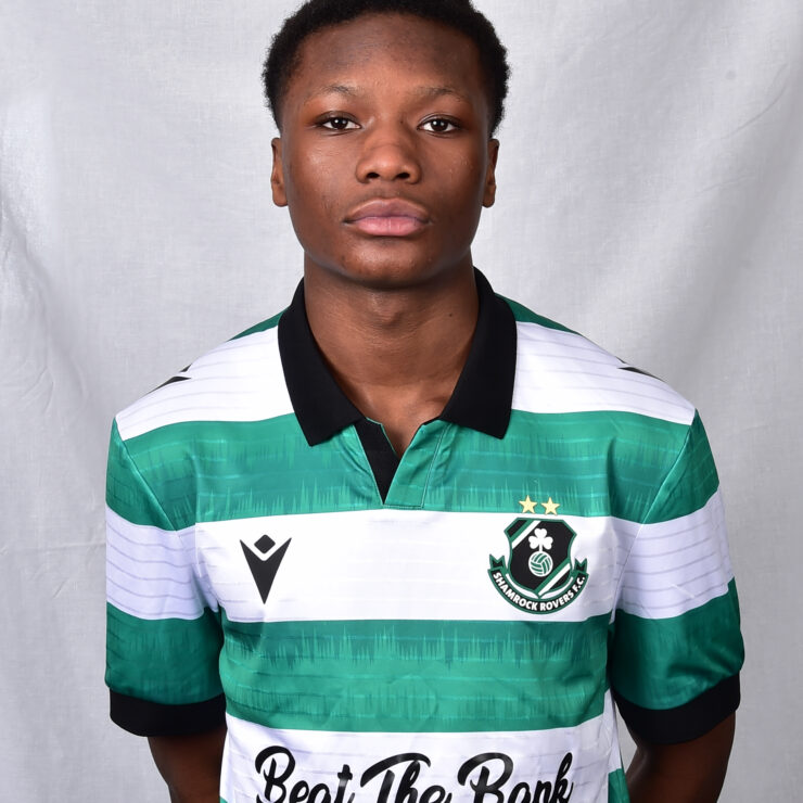 Female Shamrock Rovers player in green and white jersey, standing confidently.