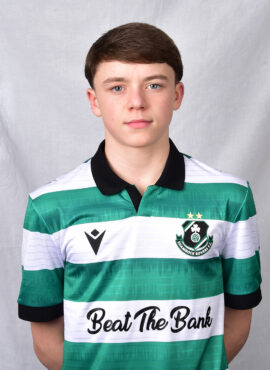 Young Shamrock Rovers player in team jersey, standing against a grey background.
