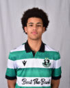 Young Shamrock Rovers player in green and white jersey, facing camera.