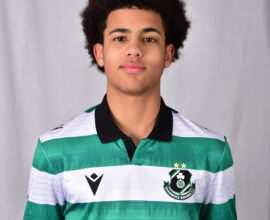 Young Shamrock Rovers player in green and white jersey, facing camera.