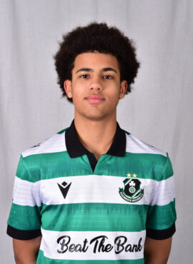 Young Shamrock Rovers player in green and white jersey, facing camera.
