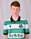 Young Shamrock Rovers player in green and white striped jersey, facing forward.