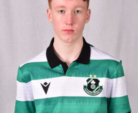 Young Shamrock Rovers player in green and white striped jersey, facing forward.