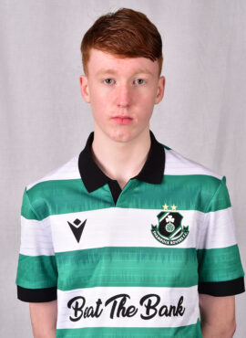 Young Shamrock Rovers player in green and white striped jersey, facing forward.