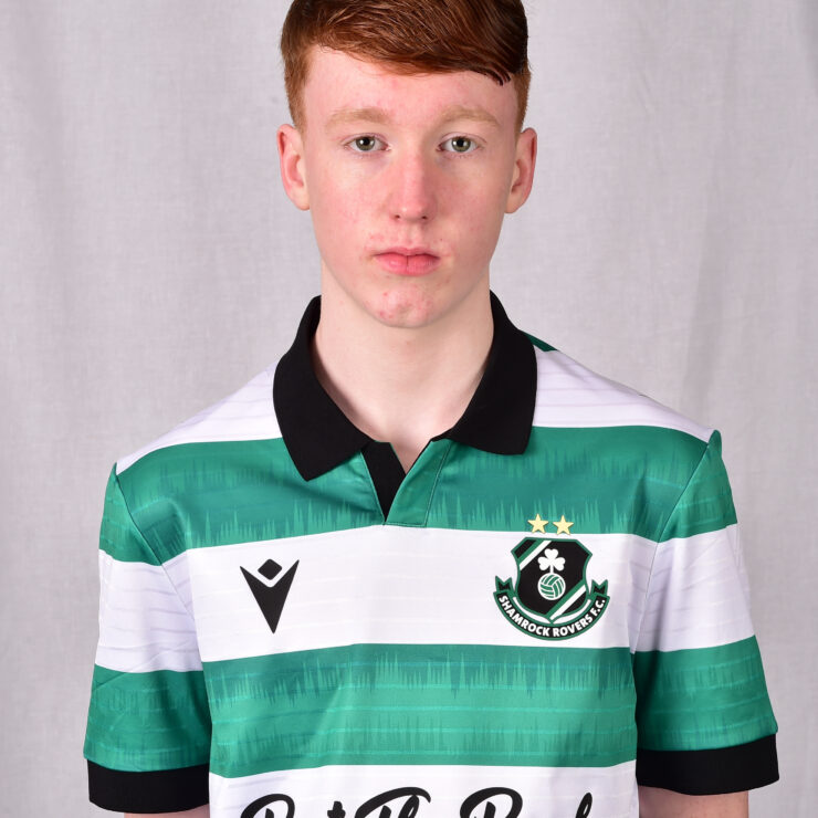 Young Shamrock Rovers player in green and white striped jersey, facing forward.