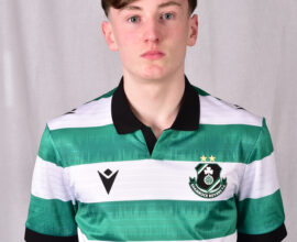 Shamrock Rovers football player in team jersey with club crest and sponsor logo.