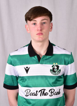 Shamrock Rovers football player in team jersey with club crest and sponsor logo.
