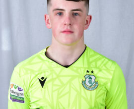Shamrock Rovers goalkeeper in bright green jersey with team crest and sponsor logo.