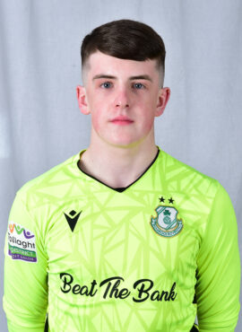 Shamrock Rovers goalkeeper in bright green jersey with team crest and sponsor logo.