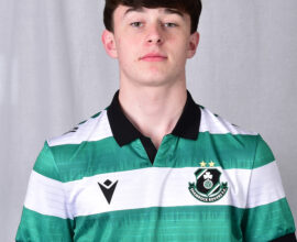 Young Shamrock Rovers football player in green and white kit.