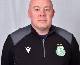 Shamrock Rovers coach in team jacket with club crest and stars.