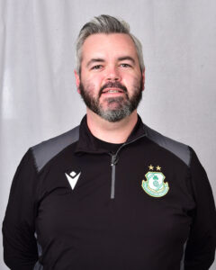 Close-up of Shamrock Rovers player in team kit, smiling.