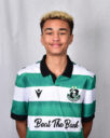 Young Shamrock Rovers player in green and white jersey smiling.