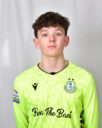 Shamrock Rovers goalkeeper wearing neon green jersey with club crest and sponsor logo.