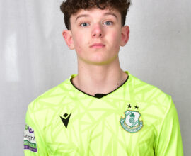 Shamrock Rovers goalkeeper wearing neon green jersey with club crest and sponsor logo.