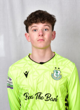 Shamrock Rovers goalkeeper wearing neon green jersey with club crest and sponsor logo.