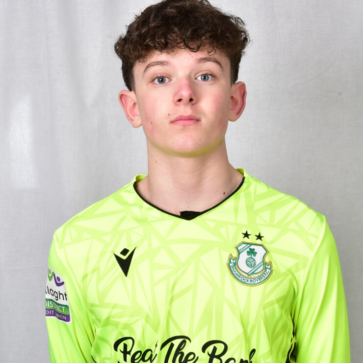 Shamrock Rovers goalkeeper wearing neon green jersey with club crest and sponsor logo.