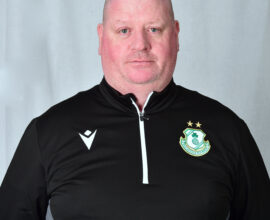 Portrait of Shamrock Rovers coach in team gear, facing camera.