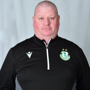 Portrait of Shamrock Rovers coach in team gear, facing camera.