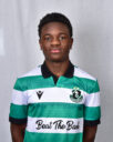 Young Shamrock Rovers player in green and white kit, standing confidently.