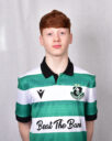 Young Shamrock Rovers player in green and white jersey, standing confidently.