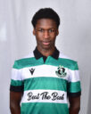 Young Shamrock Rovers footballer in green and white kit, facing forward.