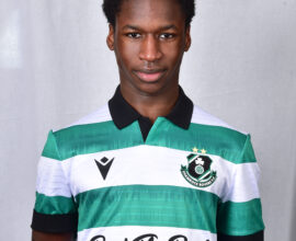 Young Shamrock Rovers footballer in green and white kit, facing forward.
