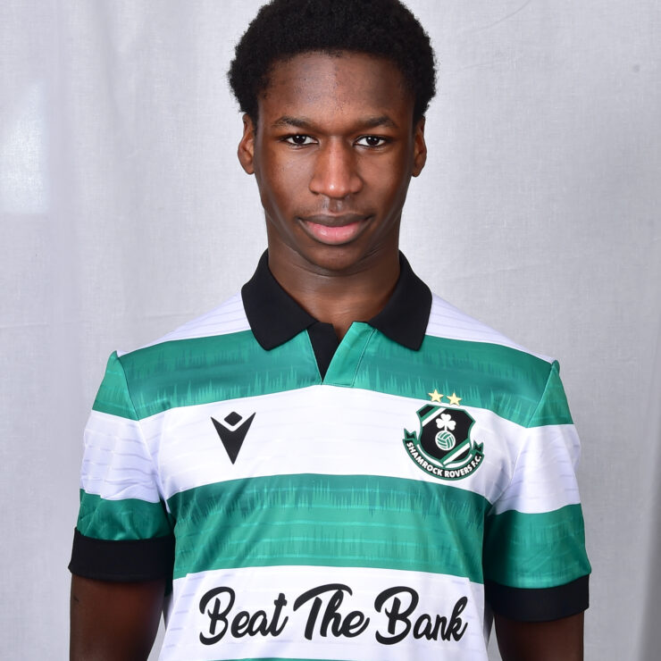 Young Shamrock Rovers footballer in green and white kit, facing forward.